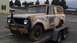 1962 International Scout 80 - This weathered vehicle is being transported on a trailer, showing significant signs of age and disrepair.