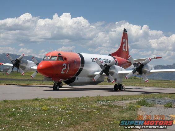 Four-engine turboprop plane with red nose and tail, marked with '21' and 'AERO UNION'