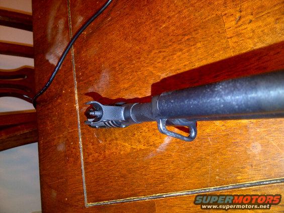 SKS rifle front sight assembly and gas block on wooden surface