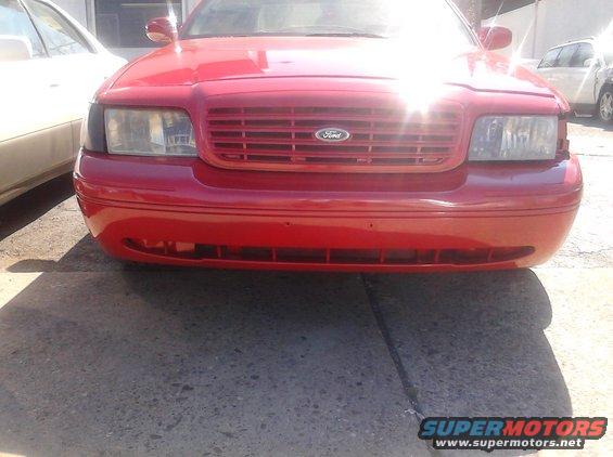 Red 1998 Ford Crown Victoria front end with horizontal grille and Ford badge