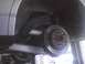 2003 Ford Crown Victoria - Underside view of a vehicle's rear brake assembly, showing the rotor and caliper.