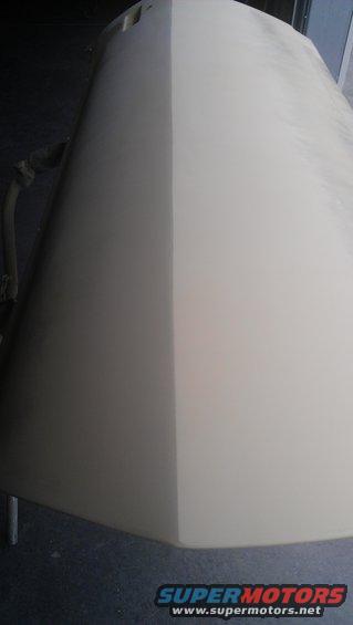 Car hood, half primer, half painted, on sawhorses