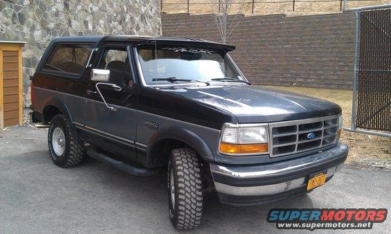 Two-tone black and grey Ford Bronco with aftermarket visor and off-road tires
