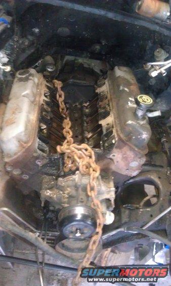 Engine block with a chain wrapped around it, possibly for removal or installation
