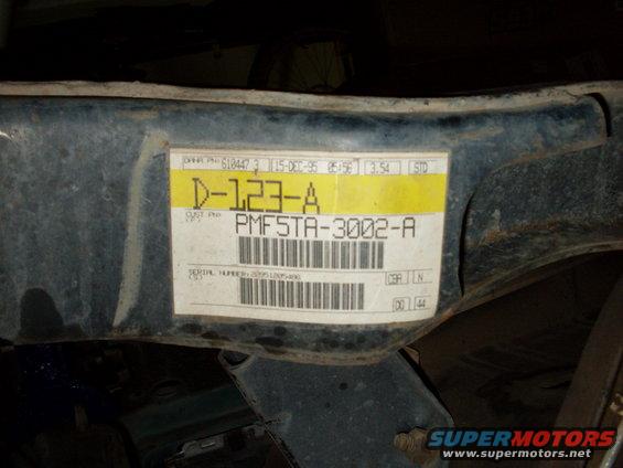 Metal frame with a white label showing "15-DEC-95" and "PMFSTA-3002-A"
