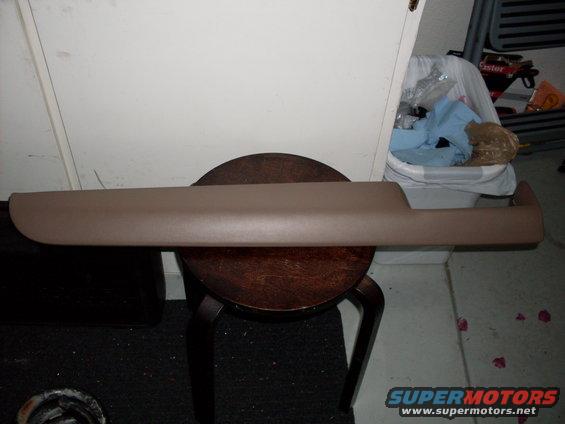 Tan interior trim piece on a wooden stool