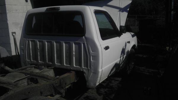 White 1987 Ford Ranger pickup truck, 3q front view, hood up