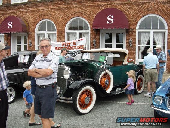 Vintage green convertible with orange wire wheels parked outside Pop's Roadhouse