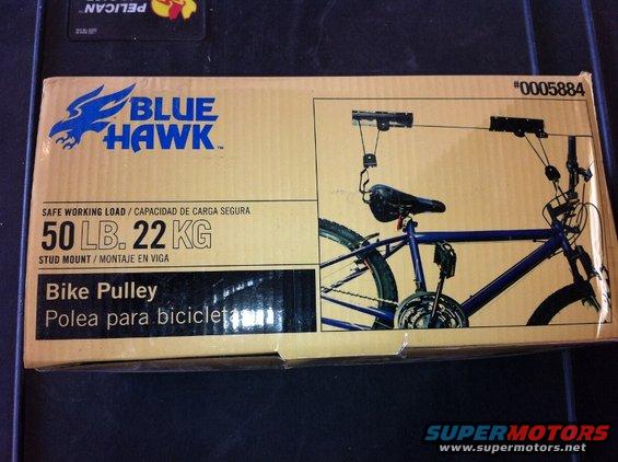 Cardboard box for Blue Hawk bike pulley system, showing a blue bicycle suspended by the pulley mechanism