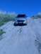 2004 Dodge Durango - Silver 2004 Dodge Durango ascends a sandy incline under a clear blue sky.