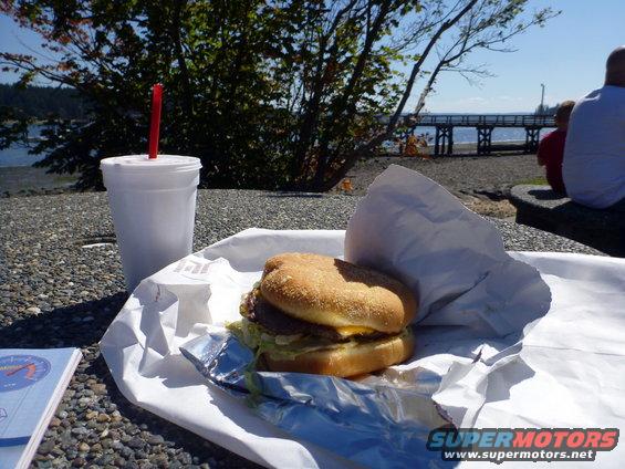 Burger and drink on a table with a waterfront view