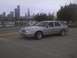 2003 Ford Crown Victoria - A silver 2003 Ford Crown Victoria is parked near a marina, with the Chicago skyline in the distance.