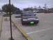 2003 Ford Crown Victoria - A black 2003 Ford Crown Victoria is parked in a lot, with another vehicle's hood open in the background.