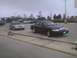 2003 Ford Crown Victoria - Two Ford Crown Victorias are parked in an outdoor lot under an overcast sky.