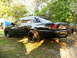 2001 Ford Crown Victoria - Rear view of a black 2001 Ford Crown Victoria with custom black wheels.
