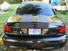 2001 Ford Crown Victoria - This black sedan features a set of racing stripes and a custom license plate.