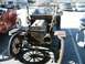 1909 Ford Model T - A vintage 1909 Ford Model T is seen from the front, parked next to another antique automobile.