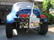 1970 Volkswagen Beetle - Rear view of a modified blue Volkswagen Beetle, often called a Baja Bug, with off-road tires and a prominent exhaust pipe.
