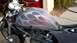 1996 Buell S1 Lightning w/Fairing - A motorcycle's fuel tank features custom flame graphics. The front of the bike and engine are partially visible.