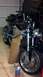1996 Buell S1 Lightning w/Fairing - A black motorcycle is parked in a garage, with a cardboard piece supporting its frame.