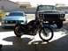 2006 Ford Mustang - A 2006 Ford Mustang is parked in front of a motorcycle and a vintage Ford truck.