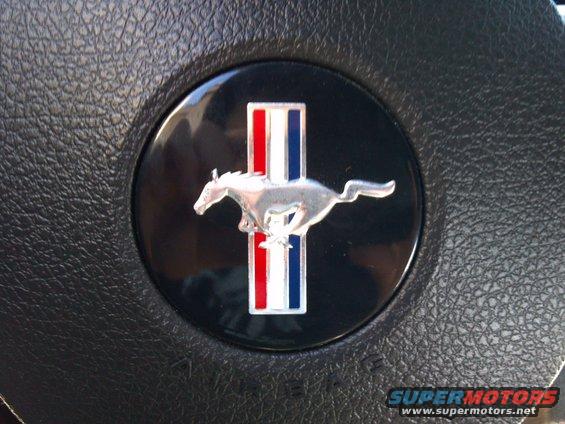 Ford Mustang emblem on black steering wheel