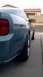 2006 Ford Mustang - Side view of a blue Ford Mustang, focusing on the rear quarter panel and wheel.
