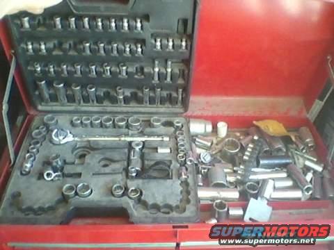 Red tool chest open, filled with various sockets and a ratchet