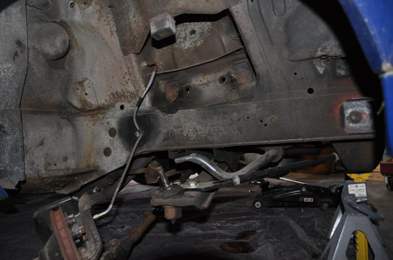 1971 Ford Mustang front suspension components on jack stands, showing rust and wear