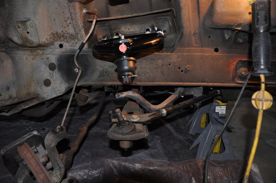 Black upper control arm assembly on a vehicle's front suspension