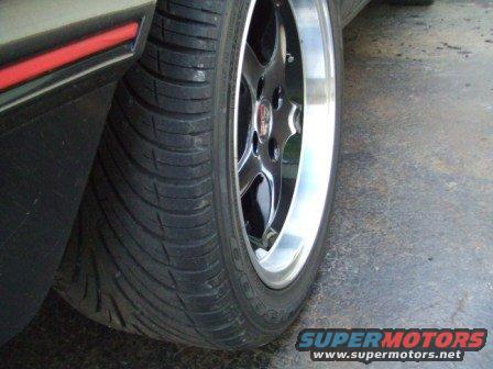 Close-up of a car wheel with a black tire and chrome lip