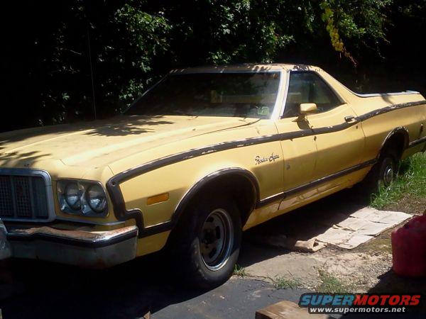 Yellow 1974 Ford Ranchero parked outdoors with trees in background