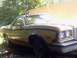 1974 Ford Ranchero - A gold 1974 Ford Ranchero is viewed from the front three-quarter angle, parked in a yard.