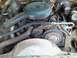 1974 Ford Ranchero - Close-up view of the engine compartment, showing various hoses, belts, and the air intake system.