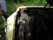 1974 Ford Ranchero - Engine bay of a yellow car, showing the radiator and engine components under the open hood.
