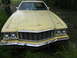 1974 Ford Ranchero - Front view of a yellow 1974 Ford Ranchero with a prominent grille and chrome bumper.