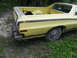 1974 Ford Ranchero - Rear view of a yellow Ford Ranchero pickup truck parked outdoors.
