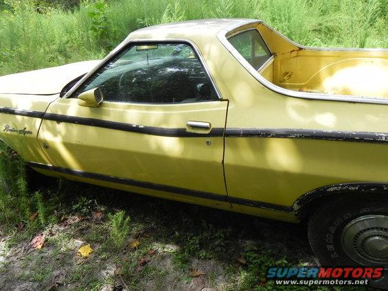 Yellow Ford Ranchero with black trim, seen from the side at a three-quarter angle