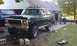 1979 Ford Bronco - This black SUV appears to be undergoing rear axle maintenance, with its suspension lifted by a jack.