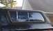 1979 Ford Bronco - Side view of a truck cap with a sliding window, showing reflections of the surroundings.
