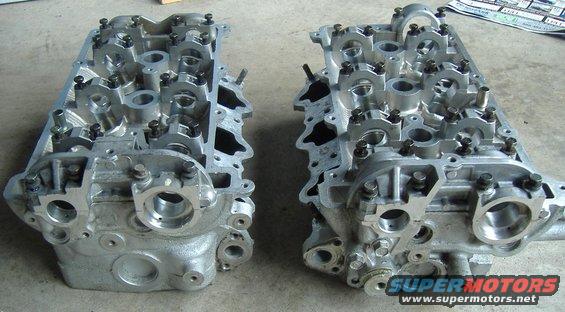 Pair of engine cylinder heads with visible camshafts and valves