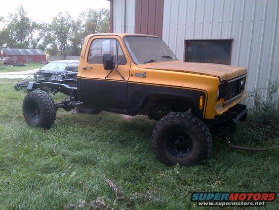 1978 Chevrolet C/K Pickup truck chassis with cab, yellow and black paint, large off-road tires