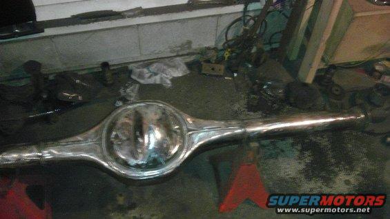 chrome rear axle assembly on jack stands in a garage