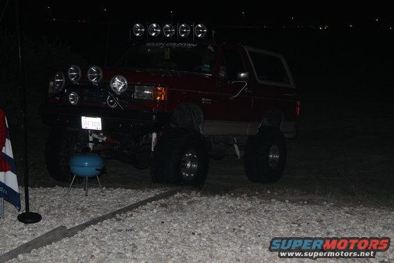 1990 Ford Bronco with multiple off-road lights mounted on the roof and bumper
