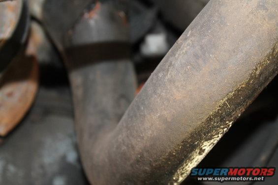 Close-up of a rusty exhaust pipe with some grime