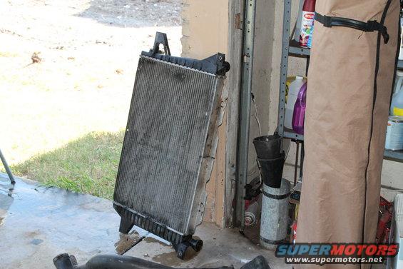 Radiator leaning against a garage wall