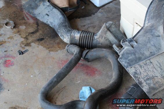 Air intake hoses and filter box on a concrete floor