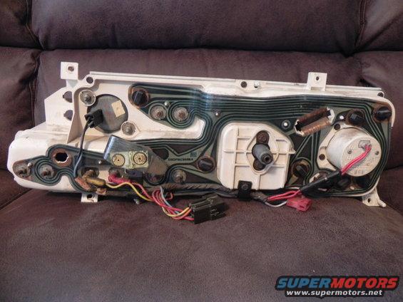 Back of a car's instrument cluster with wiring and circuit board visible
