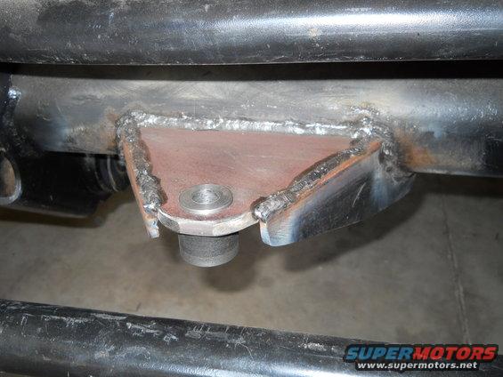 Welded bracket on vehicle frame with visible bolt