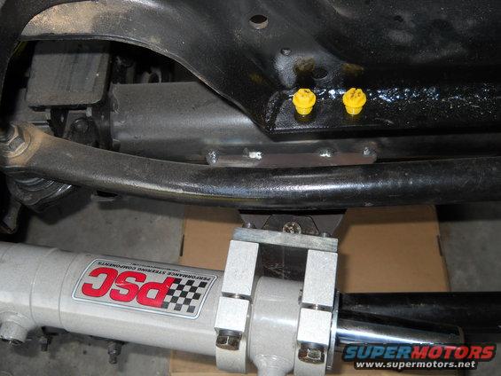Undercarriage of a vehicle with a PSC steering component and Supermotors.net logo